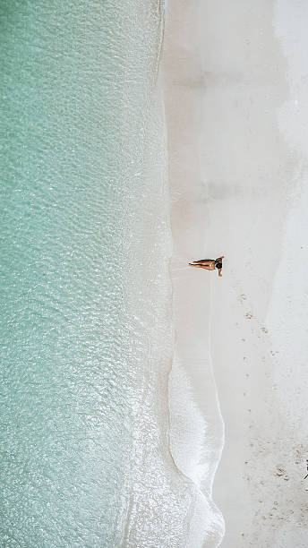 istock Woman Relaxing Alone on Tropical White Beach 2242586573