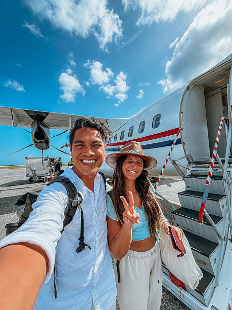 istock Happy Couple Taking Selfie Near Small Plane 2242586741