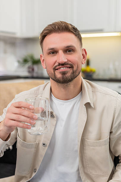 istock Young man drinks water big sip healthy habit hydration focus energy pause refresh wellness routine 2242586769