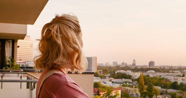 istock Woman admiring the evening sitting outside. 2242588751
