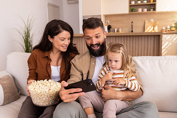 Girl watching a movie at the cinema with her mother