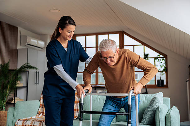 istock Nurse Helping Senior Man Use a Walker 2242596017