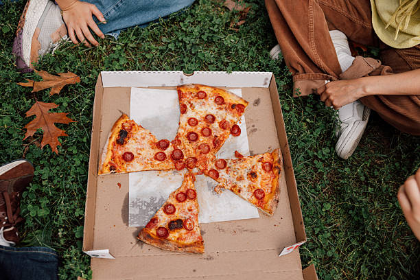 istock Joyful afternoon picnic with friends and pizza 2242596115