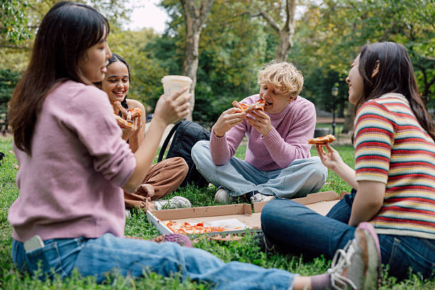 istock Youthful energy and laughter during a pizza picnic 2242596173