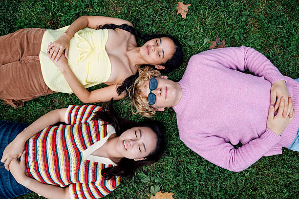 istock Young people sharing friendship and laughter in a park 2242596344