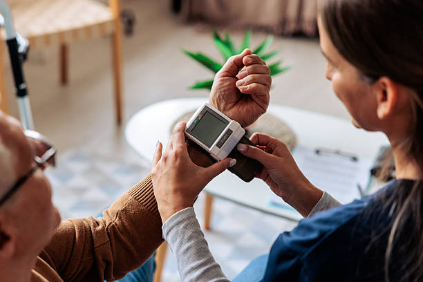 istock Nurse Measuring Senior Man's Blood Pressure 2242596562