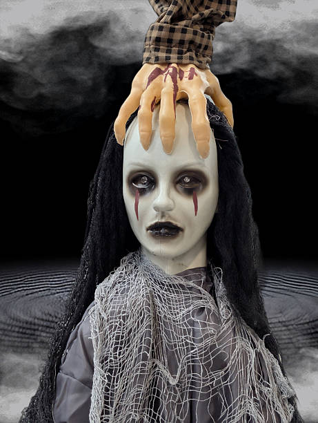 istock Haunted doll with ghostly hands in a spooky, misty setting during Halloween 2242597371