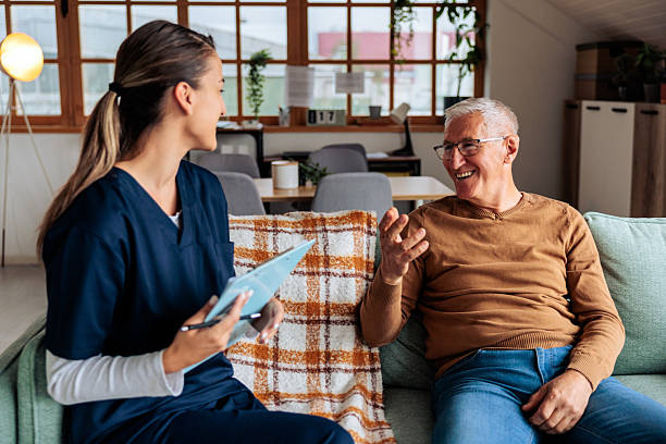 istock Nurse Talking with Senior Patient at Home Visit 2242597795