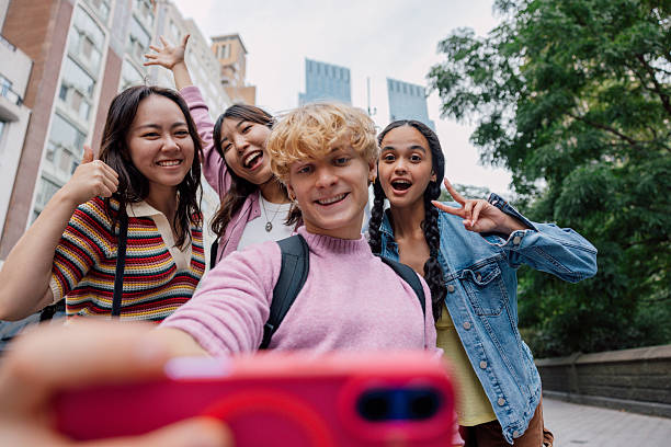 istock Happy group of students socializing outdoors in a bustling in Midtown Manhattan 2242597836