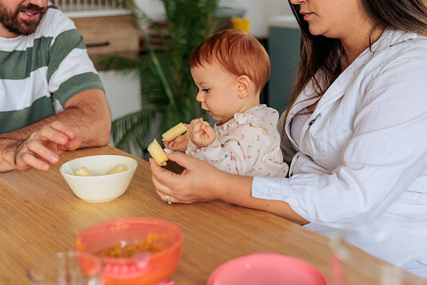 istock Parents Feeding Their Baby at the Table 2242599188