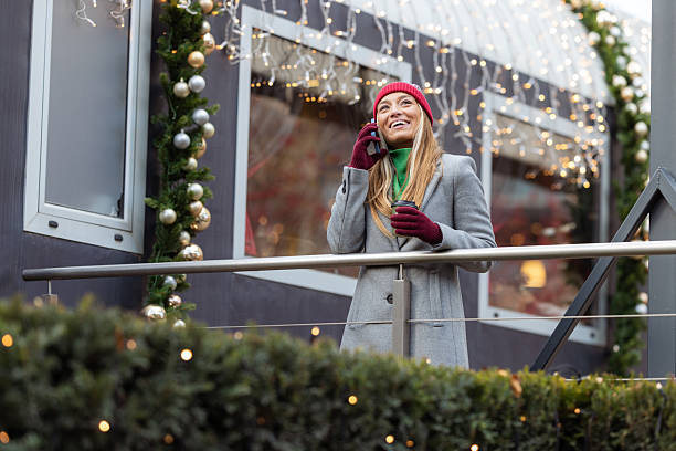 istock Young woman talking on the phone outdoors during Christmas 2242599952