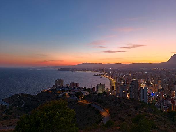 istock coastal sunset scene, twilight seaside panorama showcasing bay views and illuminated structures 2242600126