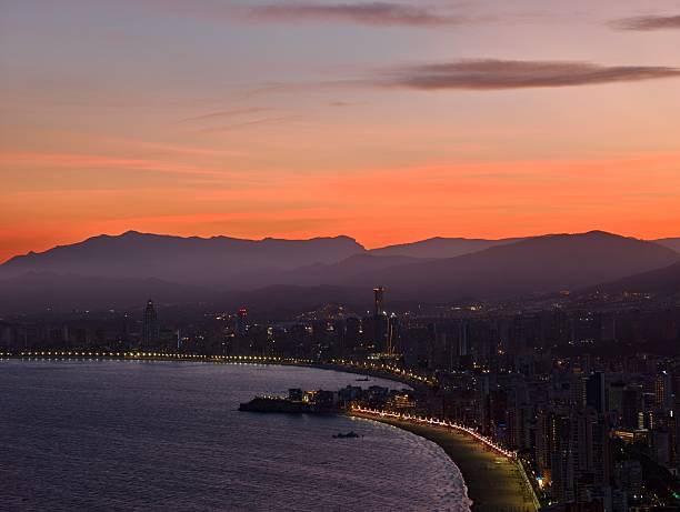 istock idyllic sunset scene featuring soft pastel hues over calm waters and mountain range in distance 2242600994