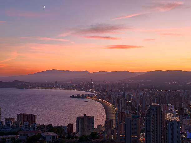 istock crescent moon over tranquil coast, serene seaside sunset illuminated by crescent moon and pastel 2242601200