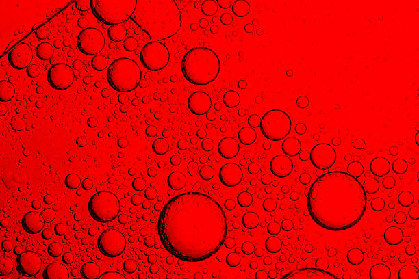 istock Close-up of red macro drink bubbles,abstract red wine bubbles, close-up shot,Macro Microscope red bubble texture close-up blood liquid, red macro bubbles Backgrounds red water drops on glass 2242602434