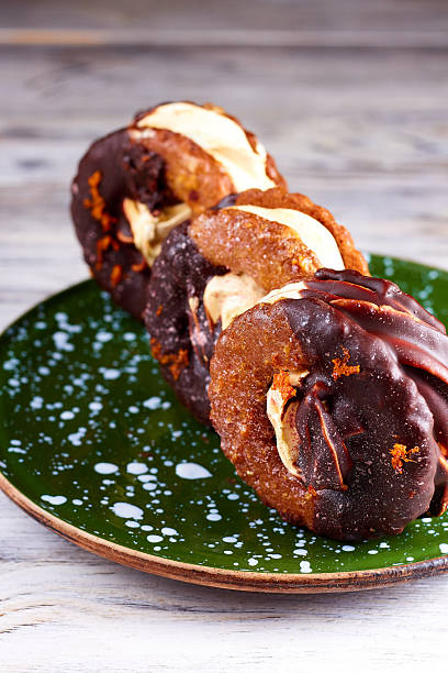 istock Three homemade chocolate covered marshmallow crackers (s'more ) on green in wite dots plate 2242602481