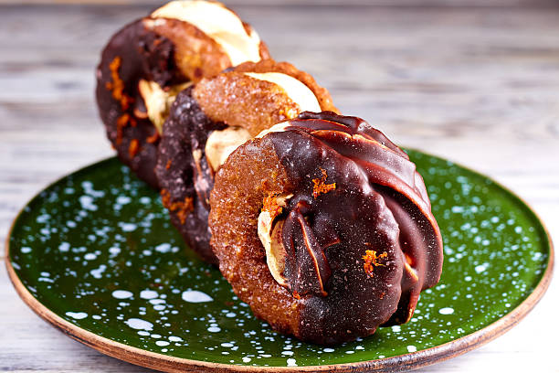 istock Three homemade chocolate covered marshmallow crackers (s'more ) on green in dots plate 2242602485