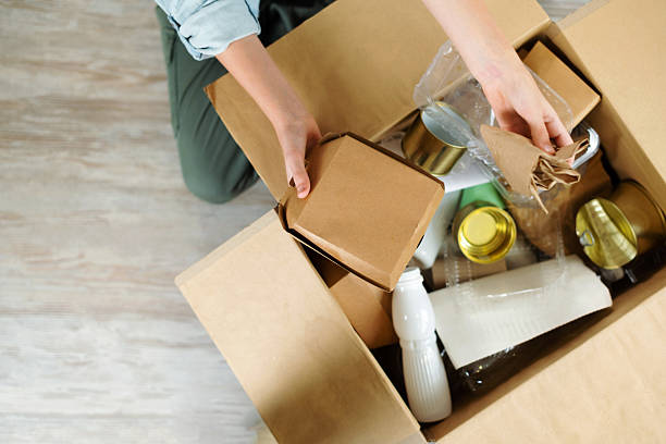 istock Kids hands sort paper and plastic into separate containers in the kitchen at home. Top view. Waste segregation, waste sorting, waste recycle. 2242604041