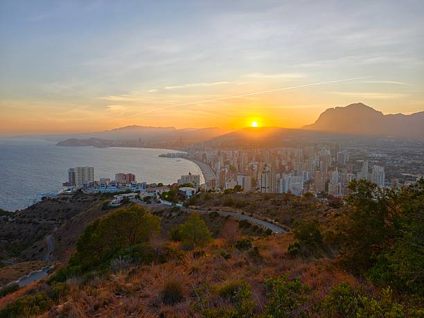 istock hiking at sunset overlooking coast, coastal city sunset viewed from hillside with rugged paths 2242607014