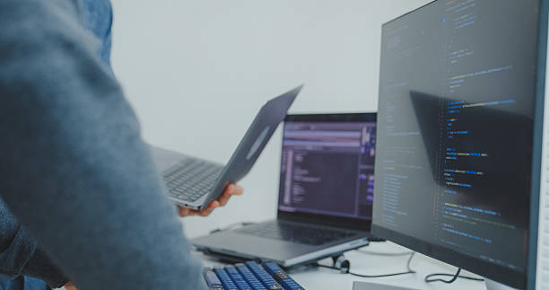 istock Closeup Black and Hispanic male engineers programmer work together collaborate discuss software strategies and code analysis for web design in tech office. Software developer, artificial intelligence. 2242608926