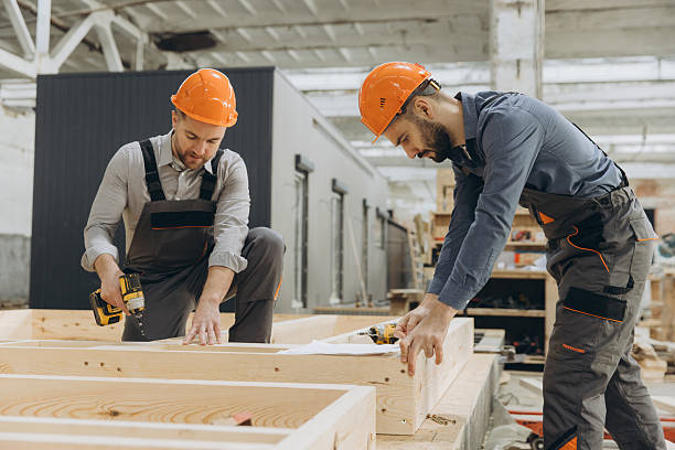 istock Carpenters building wooden frame for modular house in workshop 2242609166