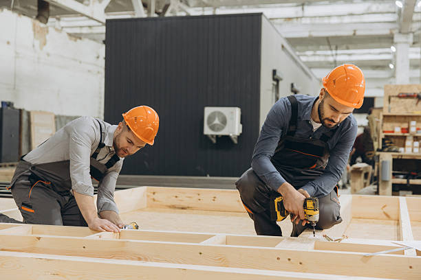 istock Construction workers building wooden frame for modular building in factory 2242609203
