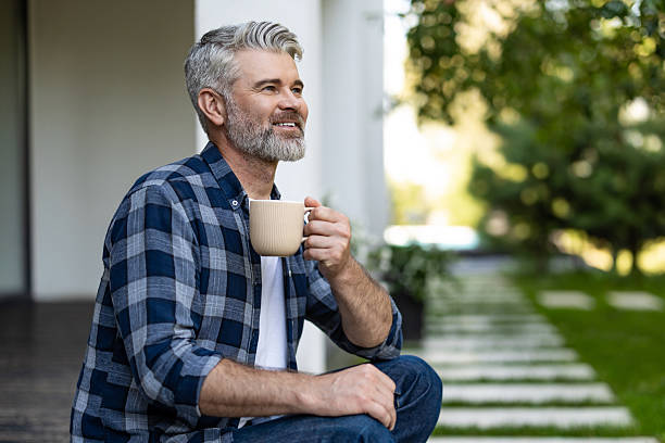 istock Contented senior bearded man with a cup of coffee in hands 2242623788