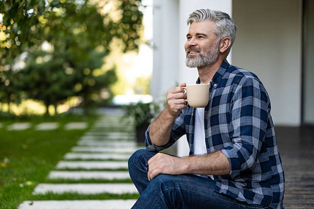 istock Contented senior bearded man with a cup of coffee in hands 2242623789