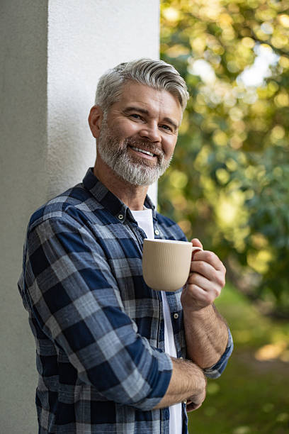istock Contented senior bearded man with a cup of coffee in hands 2242623791