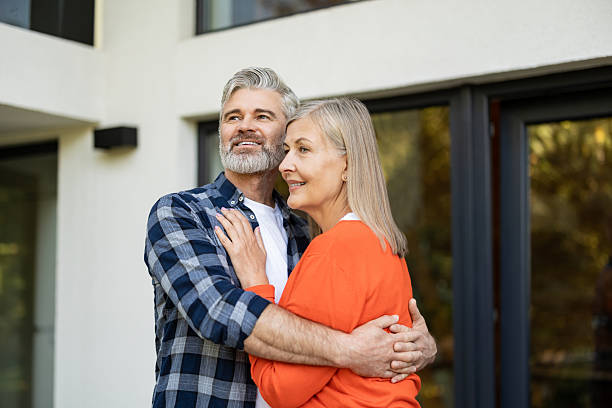 istock Gray-haired bearded man hugging his wife and smiling happily 2242623878
