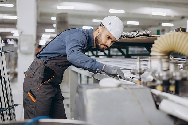 istock Factory worker operating machinery for aluminum and pvc windows and doors production 2242624988