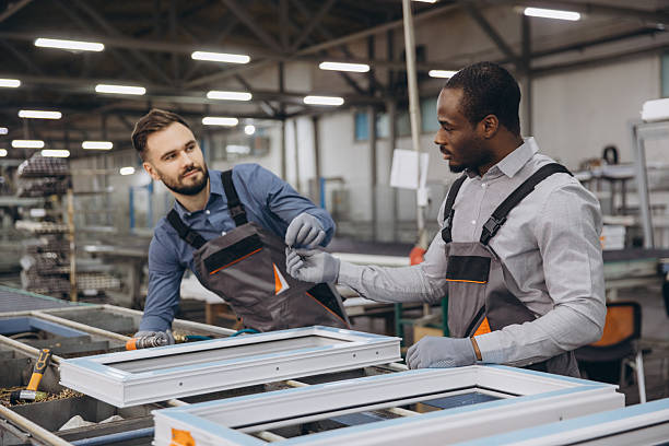 istock Factory workers assembling aluminum and PVC window frames on production line 2242625217