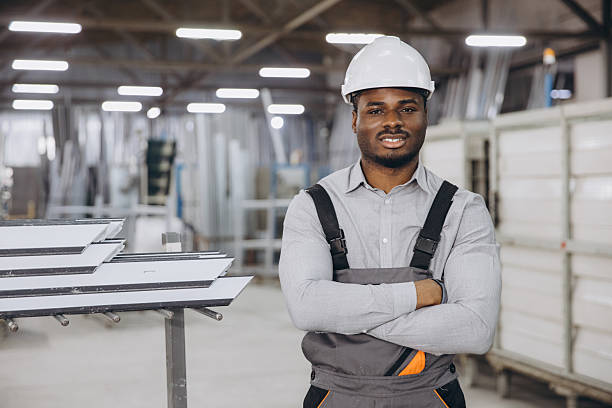 istock Factory worker posing with pvc windows and door profiles 2242625320