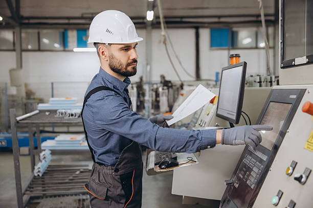 istock Factory worker operating machinery for aluminum and PVC windows and doors production 2242625351