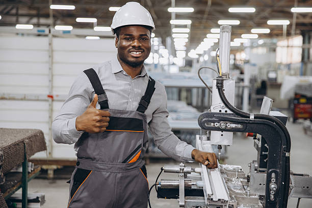 istock Factory worker making thumbs up gesture while operating industrial machinery for PVC windows and doors production 2242625520
