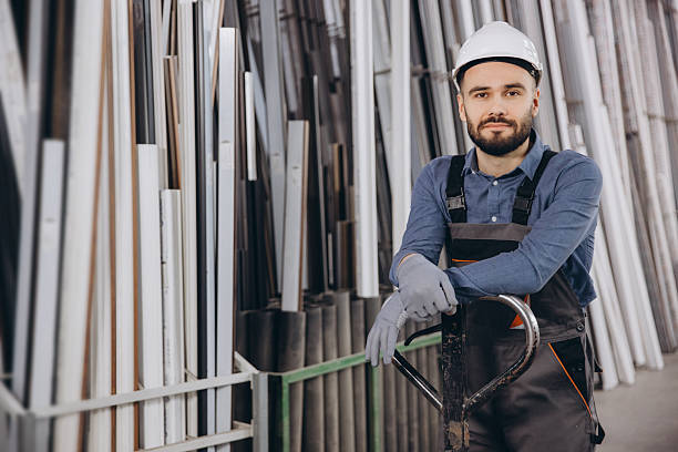 istock Factory worker posing near metal profiles for windows and doors production 2242625611