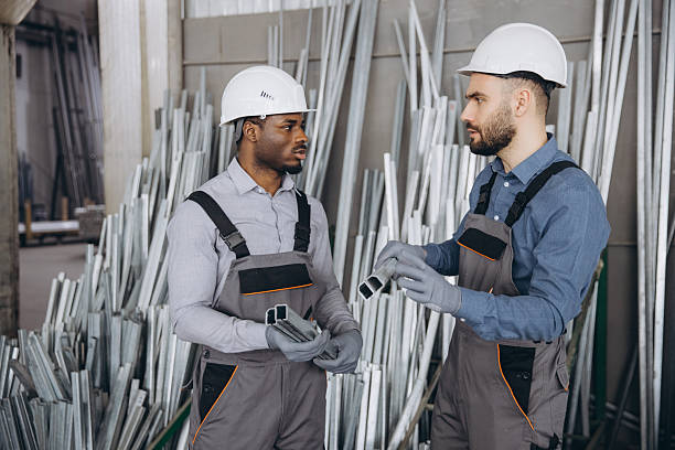 istock Two factory workers discussing aluminum profiles for windows and doors production 2242625633