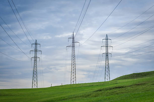 istock Power pylons march across a green, rolling landscape. 2242629894