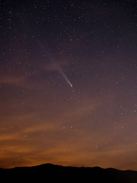 istock Comet NEOWISE streaks across a starry night sky. 2242630179