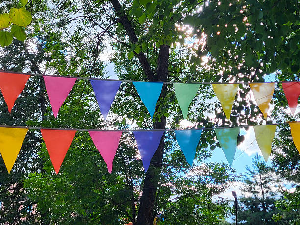 istock On a summer day, triangular colorful flags hang in the park above the alley 2242630592