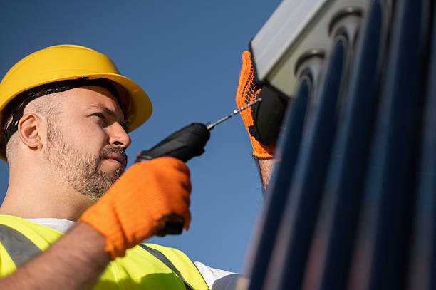 istock Technician wearing gloves inspecting solar power tubes on roof 2242631944
