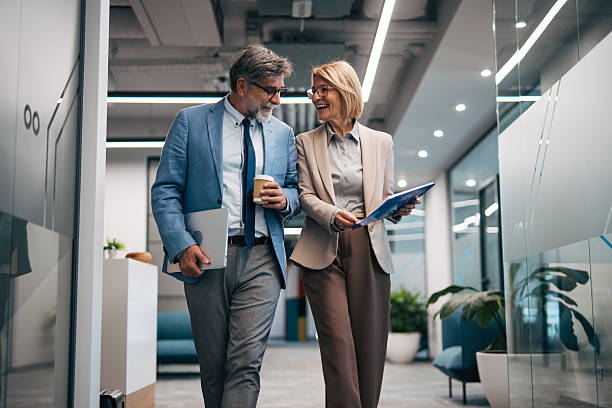 istock Business people walking and discussing in office hallway 2242632515