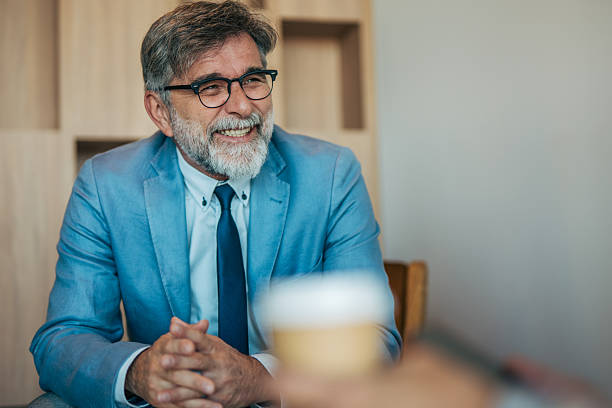 istock Senior businessman smiling during a professional meeting 2242633732