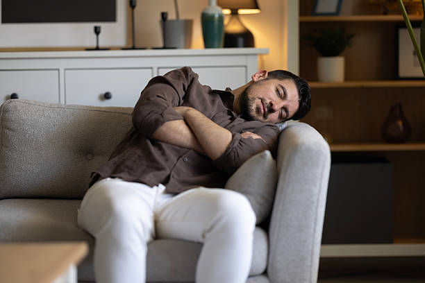 istock Man With Lethargy And Fatigue On Couch 2242634639