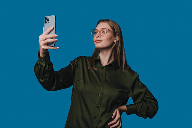 istock A Confident Young Woman Happily Taking a Selfie Against a Bright Blue Background 2242634869