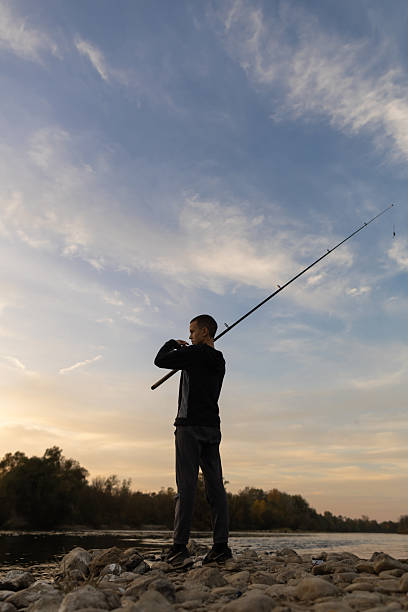 Boy fishing on the riverbank. Serbia