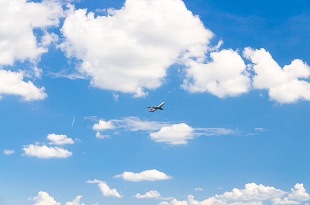 istock Airplane take off into a blue sky with white clouds, Passenger plane aircraft flying on blue sky background 2242637565