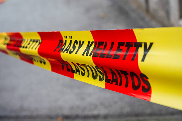 istock Warning tape with Finnish text translated to restricted area. 2242637632