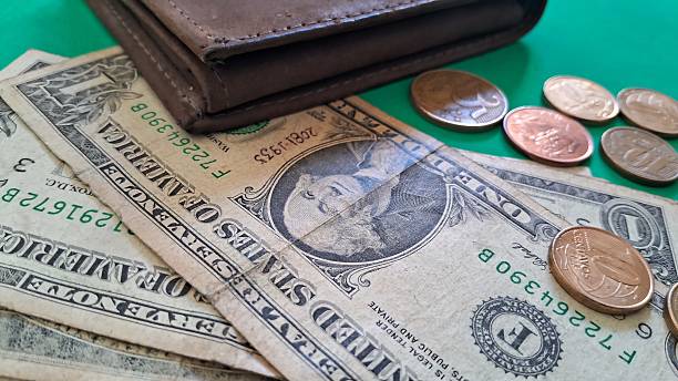 istock Wallet with Dollar Bill and Coins on Green Background 2242640588