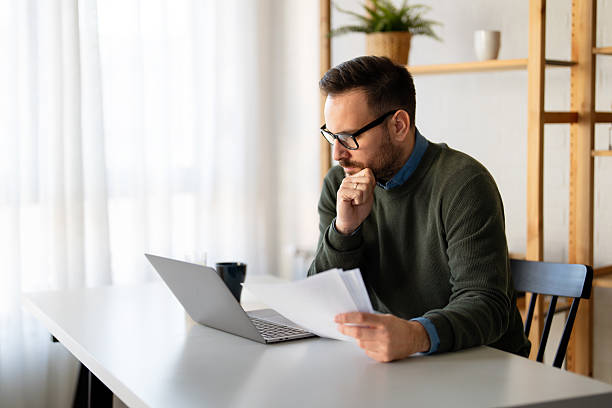 istock Success man typing on laptop, communicating online distantly working or studying on computer at home 2242640663